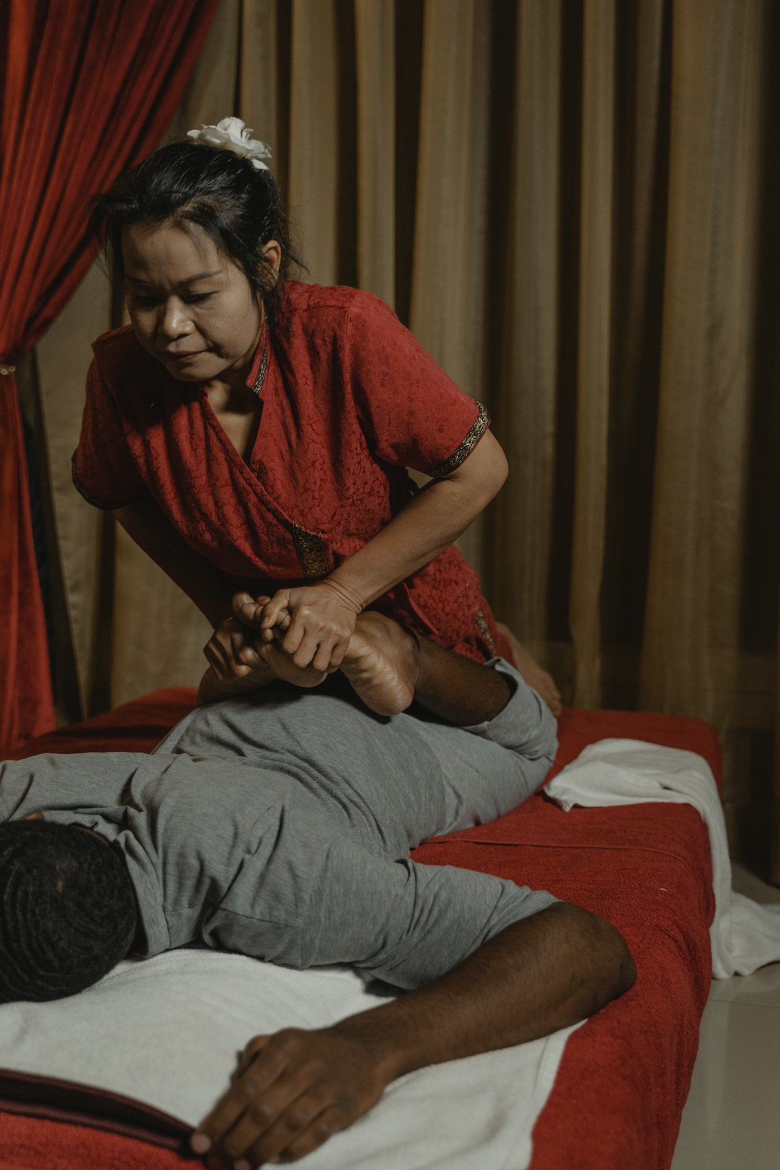 Woman in Red Shirt Making Thai Massage 